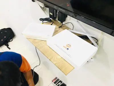 a man is sitting in front of a computer monitor at Bismillah Homestay Muslem NETFLIX UNIFI HIGH SPEED in Kamunting
