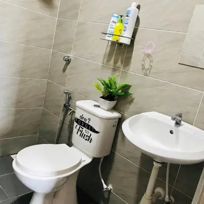 a bathroom with a toilet and a sink at Haaniy Homestay Casa Kayangan Meru in Ipoh