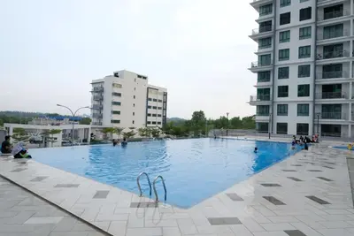 a large swimming pool in the middle of a building at Haaniy Homestay Casa Kayangan Meru in Ipoh