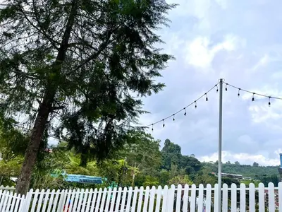 a white picket fence with a white at Blue Cabins By Pfordten Cottage in Cameron Highlands