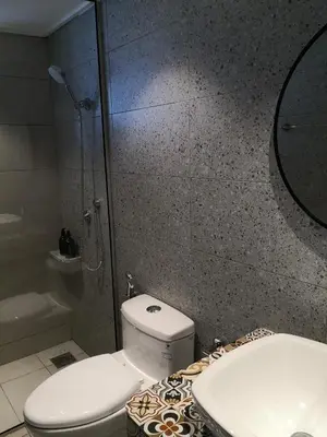 a bathroom with a toilet and a shower and a sink at The Hill at Fraser Hill in Bukit Fraser