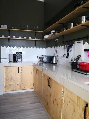 a kitchen with wooden cabinets and a white counter top at The Hill at Fraser Hill in Bukit Fraser