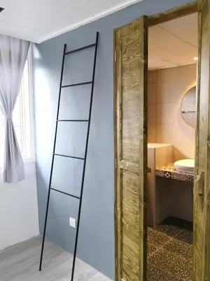 a bathroom with a wooden door and a mirror at The Hill at Fraser Hill in Bukit Fraser