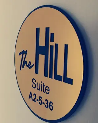 a sign for the hill clinic on a wall at The Hill at Fraser Hill in Bukit Fraser