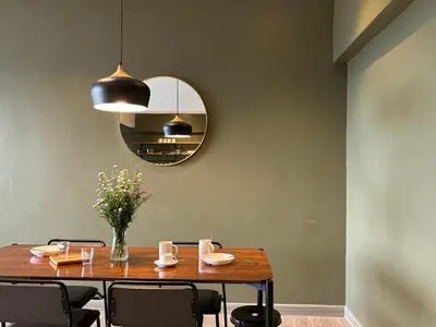 a dining room with a table and a mirror at The Hill at Fraser Hill in Bukit Fraser
