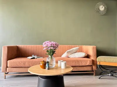 a living room with a couch and a table with flowers at The Hill at Fraser Hill in Bukit Fraser