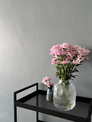a vase with pink flowers sitting on a table at The Hill at Fraser Hill in Bukit Fraser