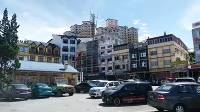 a city with cars parked in a parking lot at Merlin Home@Crown Imperial Court in Tanah Rata