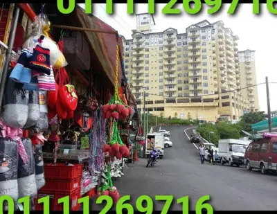 a market with a building in the background at Crown imperial in Brinchang