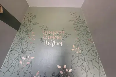 a room with a wall with flowers on it at Inapan Taman Herba in Kepala Batas