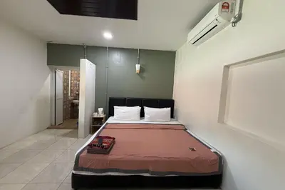 a bedroom with a bed in a room at Inapan Taman Herba in Kepala Batas