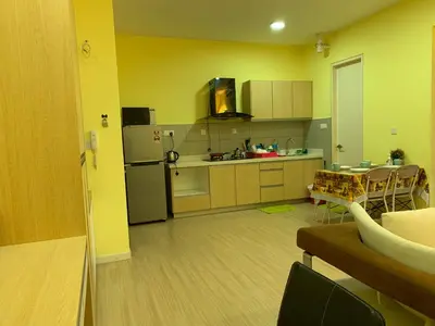 a kitchen with yellow walls and a table and a refrigerator at Woodsbury homestay Studio 57 Butterworth in Butterworth