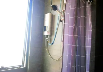 a shower in a bathroom with a purple shower curtain at Woodsbury homestay Studio 57 Butterworth in Butterworth