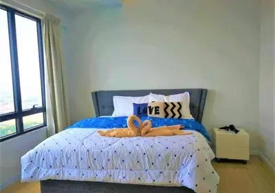a bedroom with a blue bed with two stuffed animals on it at Woodsbury homestay Studio 57 Butterworth in Butterworth
