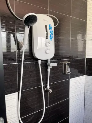 a hair dryer is attached to the wall of a bathroom at Reno Hotel Ipoh in Ipoh