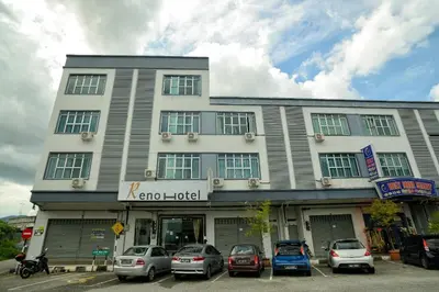 a building with cars parked in front of it at Reno Hotel Ipoh in Ipoh
