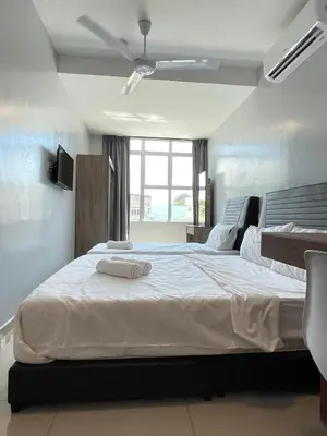 a bedroom with a large bed with two towels on it at Reno Hotel Ipoh in Ipoh