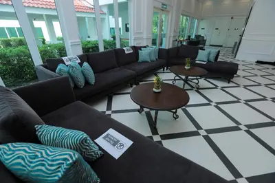 a living room with couches and tables at Hotel Casuarina@Kuala Kangsar in Kuala Kangsar