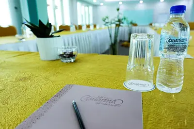 a bottle of water sitting on top of a table at Hotel Casuarina@Kuala Kangsar in Kuala Kangsar