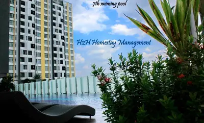 a sign for aominiumominium with a swimming pool and buildings at H2H - Botanical Majestic Ipoh in Ipoh