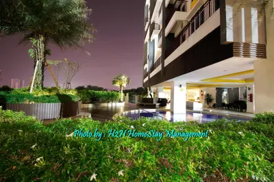 a building with a swimming pool in front of it at H2H - Botanical Majestic Ipoh in Ipoh