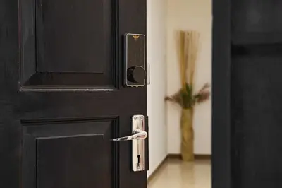 a black door with a lock on it with a vase at Ipoh Garden Comfort Homestay in Ipoh