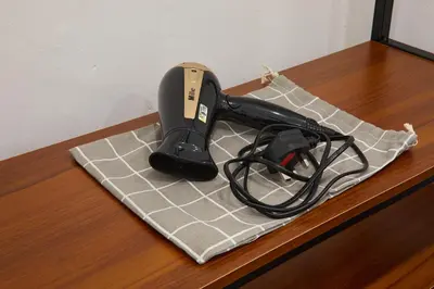 a hair dryer on a cutting board on a counter at Ipoh Garden Comfort Homestay in Ipoh