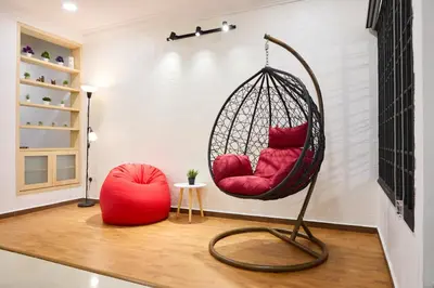 a swing with two red pillows in a room at Ipoh Garden Comfort Homestay in Ipoh