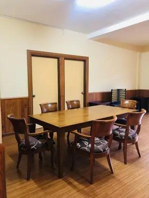 a conference room with a wooden table and chairs at 3 Rooms Apt @ Crown Imperial Court in Cameron Highlands