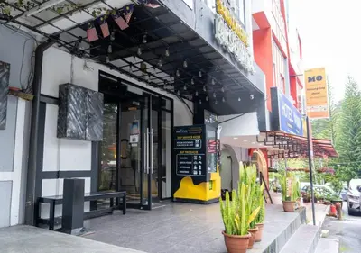 a building with a bench in front of a store at Kavy Boutique Hotel @ KBH in Brinchang