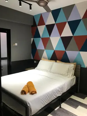a bed with two slippers on it in front of a mural at Kavy Boutique Hotel @ KBH in Brinchang