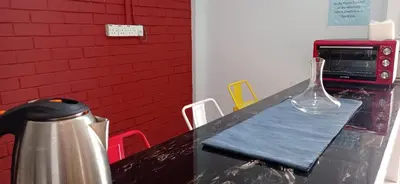 a table with a glass vase sitting on top of it at 4B12B 20 pax Corner House in Ipoh