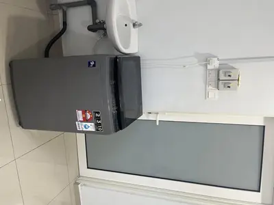 a microwave oven hanging from a wall in a bathroom at 4B12B 20 pax Corner House in Ipoh