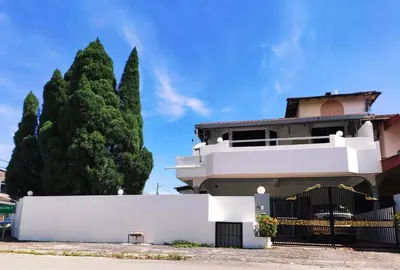 a white house with a fence and a tree at 4B12B 20 pax Corner House in Ipoh