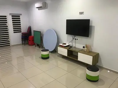 a living room with a flat screen tv on a wall at 4B12B 20 pax Corner House in Ipoh