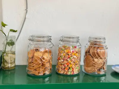 four glass jars filled with different types of food at Attic Hotel in George Town