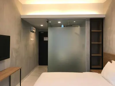 a room with a bed and a sliding glass door at Dandelion Inn in Simpang Pulai