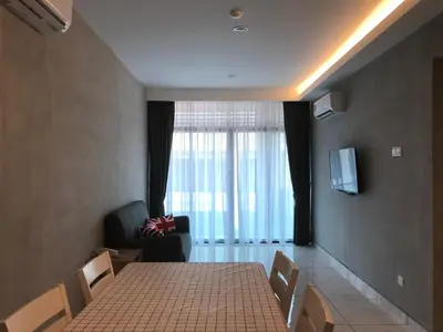 a room with a table and chairs and a large window at Dandelion Inn in Simpang Pulai