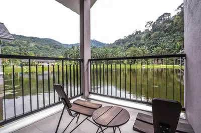 a balcony with a table and chairs and a view at Sementra Hot Spring Nature Resort in Gopeng