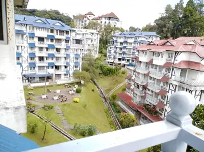 a view from a balcony of buildings and a park at Homstay Desa Anthurium in Tanah Rata