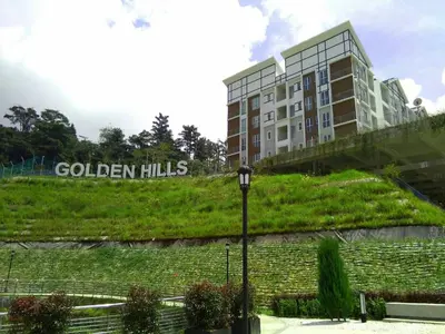 a building with the words golden hills next to a street light at Barrington Square 2 Rooms Apartment at Golden Hill Night Market in Brinchang