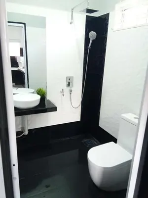 a bathroom with a white toilet and a sink at Serantau Mayang by the Bliss in Bagan Serai