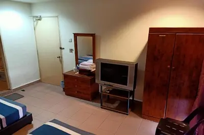 a living room with a tv and a dresser with a tvictericter at Hotel O Prai Jaya in Perai
