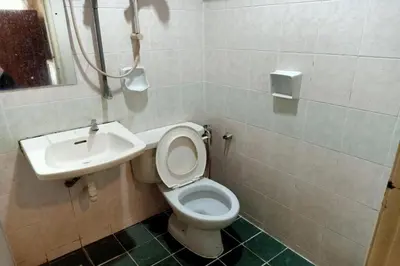 a bathroom with a toilet and a sink at Hotel O Prai Jaya in Perai