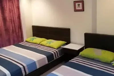 a bedroom with two beds with yellow and blue at Hotel O Prai Jaya in Perai