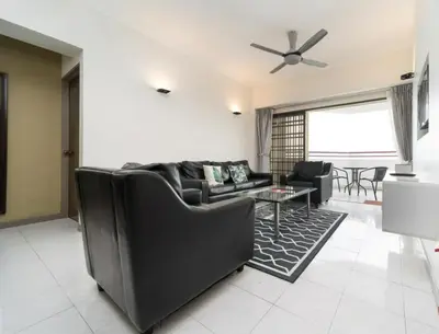 a living room with a couch and a table at Deluxe VIP Seaview Batu Ferringhi 1503 - 3 Rooms in Batu Ferringhi