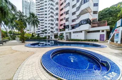 a swimming pool in front of a building at Deluxe VIP Seaview Batu Ferringhi 1503 - 3 Rooms in Batu Ferringhi