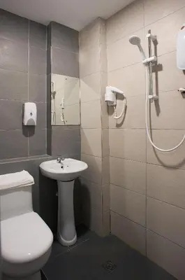 a bathroom with a shower and a toilet and a sink at Econtel Queensbay in Bayan Lepas