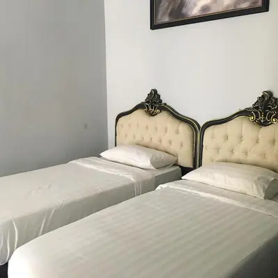 two beds sitting next to each other in a room at Zetter Suites by Dreamscape in Cameron Highlands