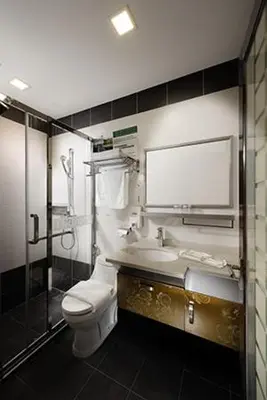 a bathroom with a toilet and a sink and a shower at ERNES Hotel Bayu Mutiara in Bukit Mertajam